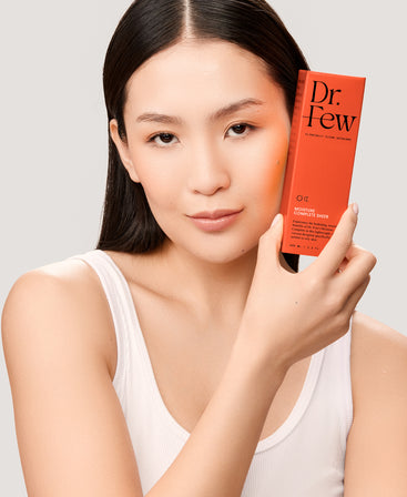 Woman holding Dr. Few Skincare Moisture Complete Sheer box