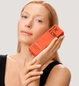 Woman holding Dr. Few Skincare Moisture Complete box 