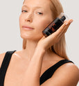 Woman holding Dr. Few Skincare Supreme Oil Serum