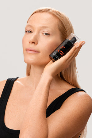 Woman holding Dr. Few Skincare Supreme Oil Serum