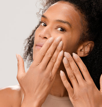 Woman applying Dr. Few Skincare Tinted Mineral Sunscreen onto face