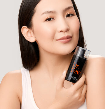 woman holding Dr. Few Skincare tinted mineral sunscreen SPF 30