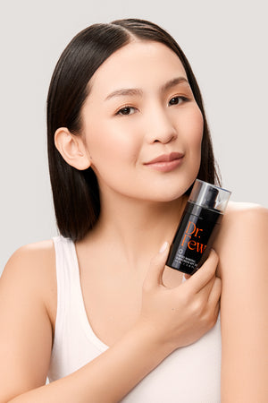 woman holding Dr. Few Skincare tinted mineral sunscreen SPF 30
